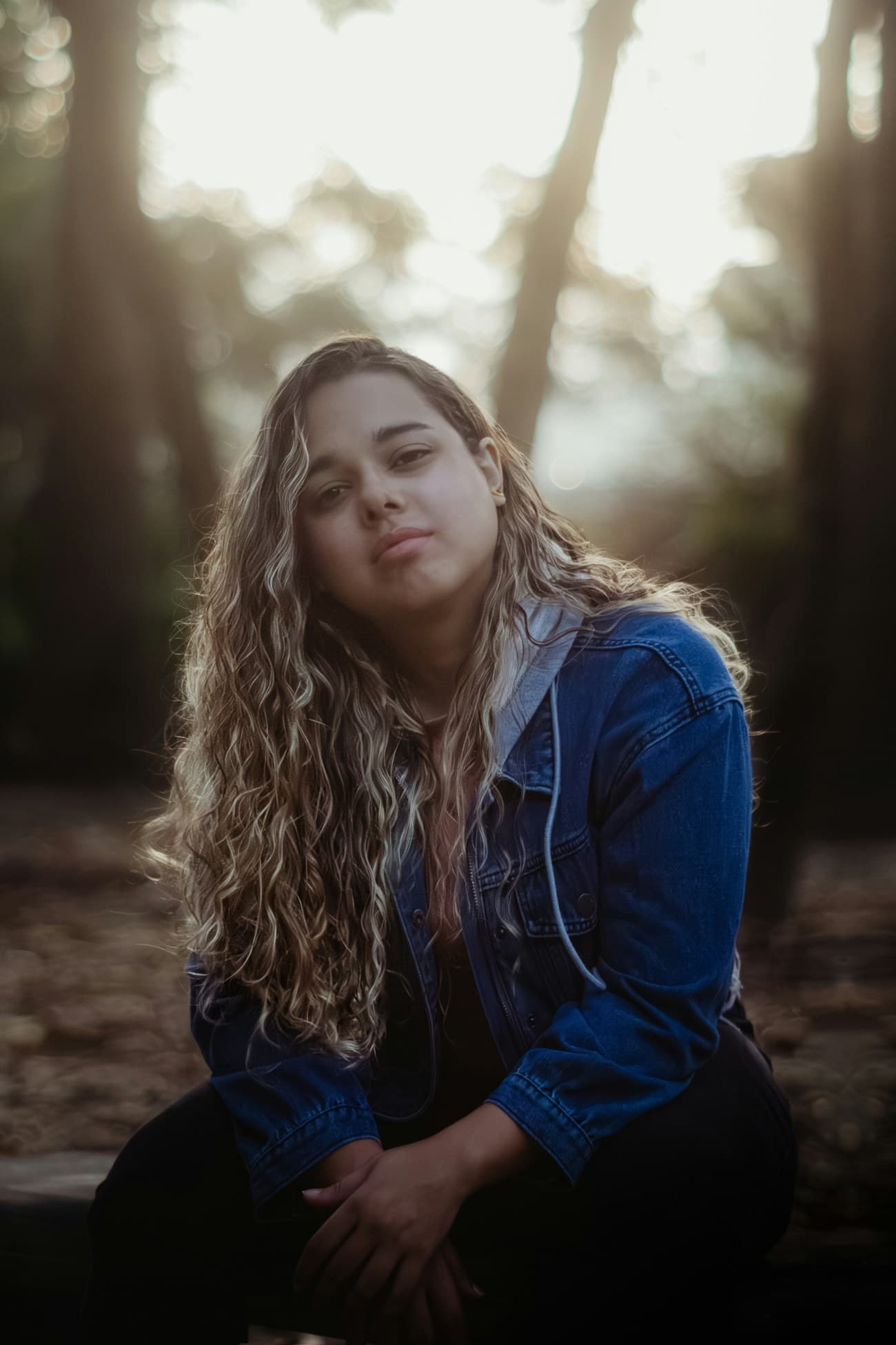 A teen in a quiet, reflective moment in warm natural light